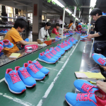 Where are Nike trainers manufactured: A close-up of a Nike trainer being assembled in a factory