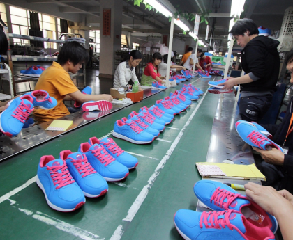 Where are Nike trainers manufactured: A close-up of a Nike trainer being assembled in a factory